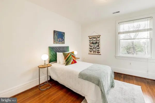 a bedroom with a bed and window