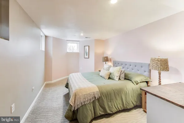 a bedroom with a bed and a lamp