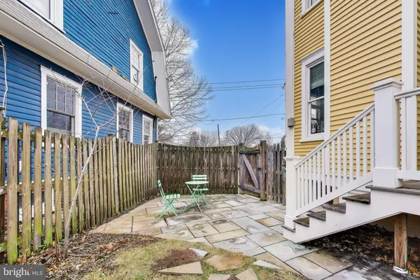 a view of a brick house with wooden fence