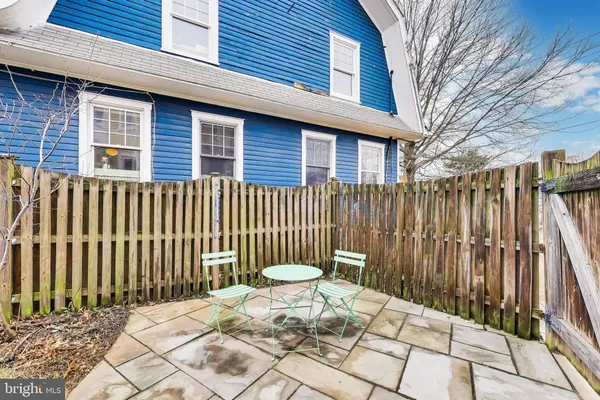 a view of a brick house with wooden fence