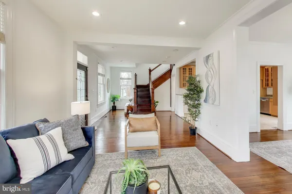 a living room with furniture and wooden floor