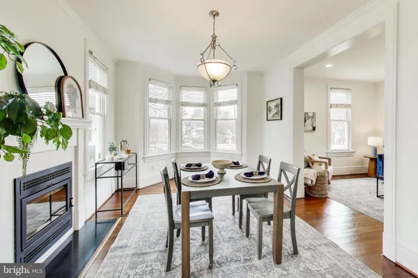 a dining room with furniture and wooden floor