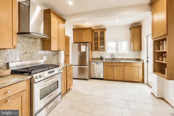 a kitchen with a stove a sink and a refrigerator
