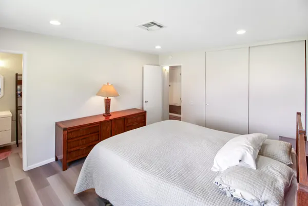 a bedroom with a bed and a lamp
