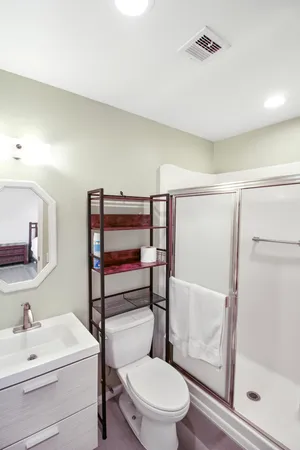 a white toilet sitting next to a bathroom sink