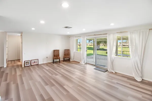 a view of a livingroom with a furniture and wooden floor