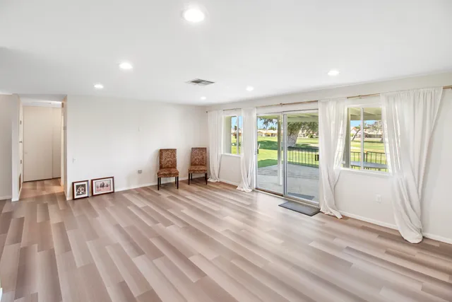 a view of a livingroom with a furniture and wooden floor