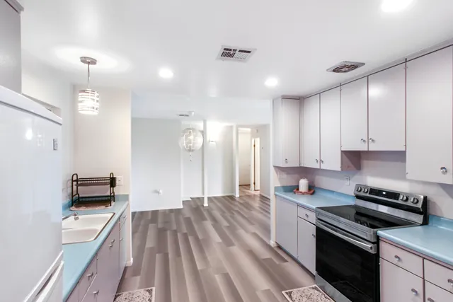 a kitchen with a sink stainless steel appliances and cabinets