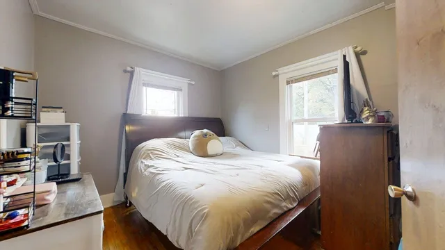 a bedroom with a bed and a mirror