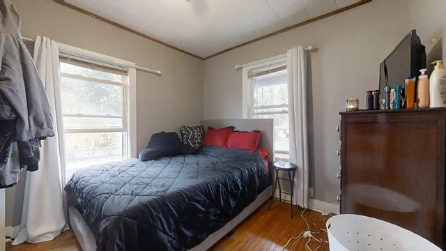 a bedroom with a bed and a window