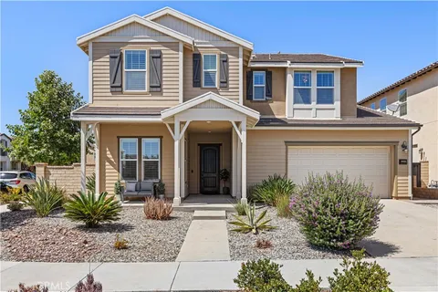 a front view of a house with porch and livingroom