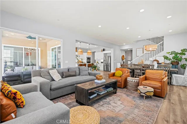 a kitchen with stainless steel appliances a dining table chairs and white cabinets