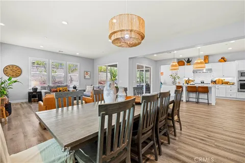 a living room with patio furniture and a floor to ceiling window