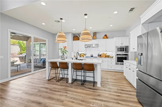 a living room with lots of furniture and a hard wood floor