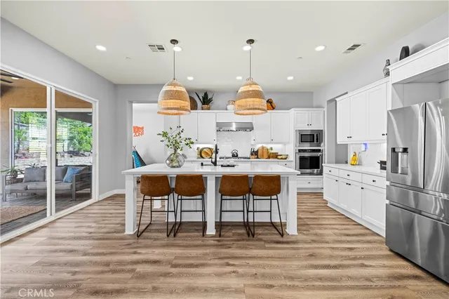 a spacious bedroom with a bed and a chandelier