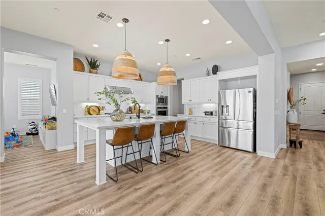 a view of walk in closet with clothes