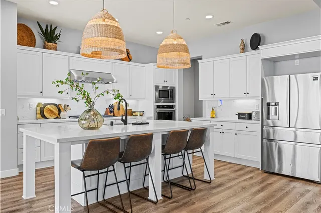 a bathroom with a sink vanity mirror and toilet