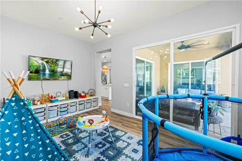 a living room with fireplace furniture and a wooden floor