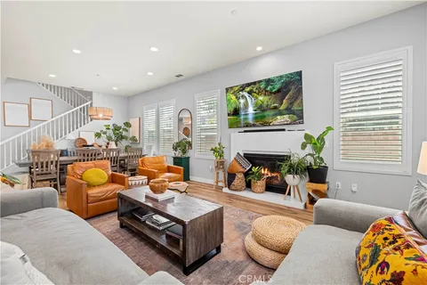 a dining room with furniture a window and wooden floor