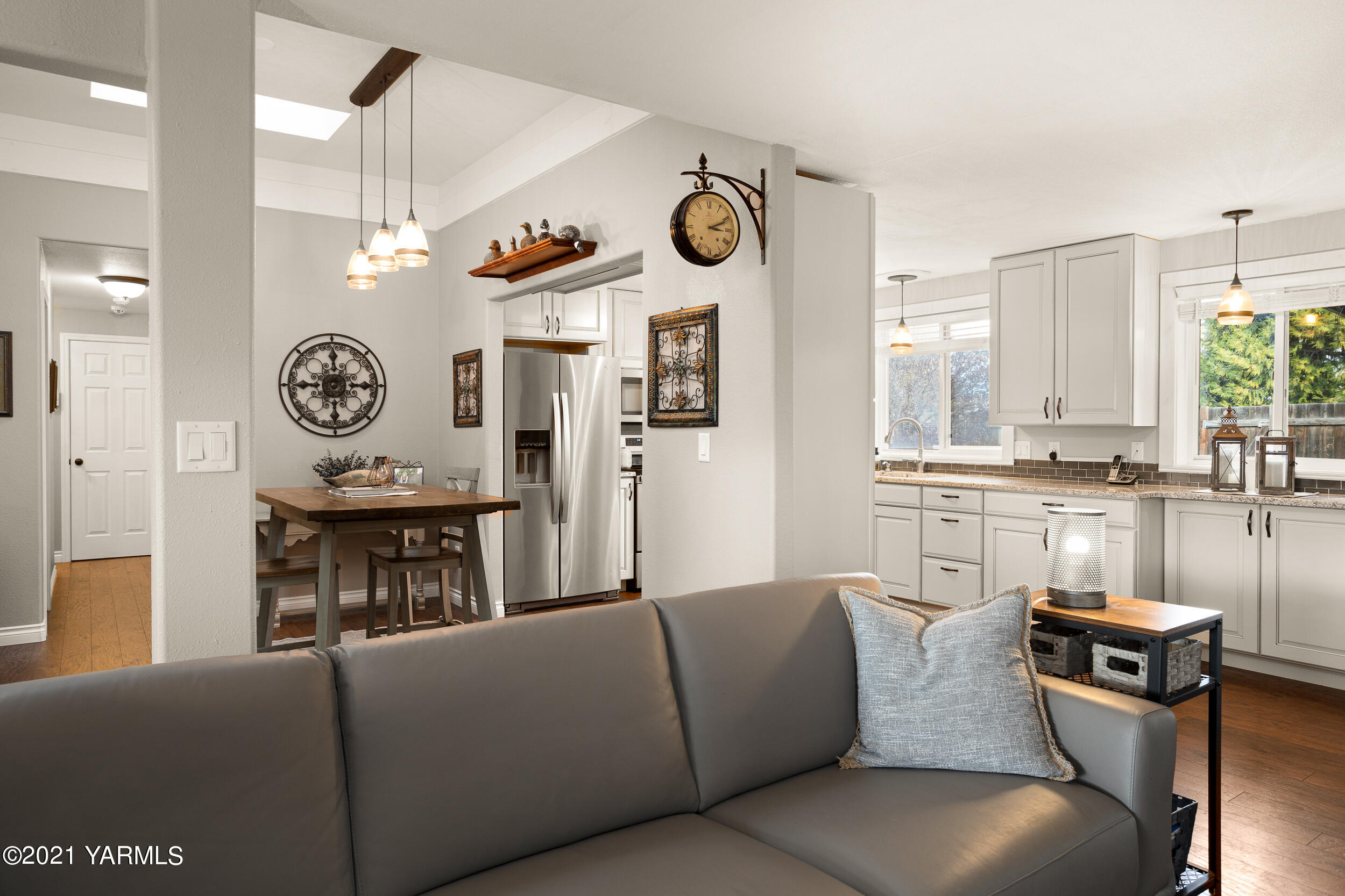 1517 South 32nd Avenue Yakima, WA 98902 - Photo 6 of 21 a living room with furniture a clock on wall and a clock