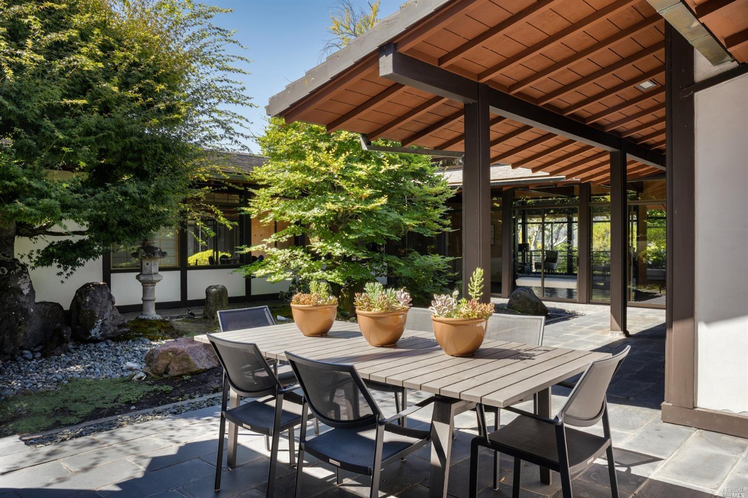 21 Canyon Road Ross, CA 94957 - Photo 16 of 41 a view of an outdoor dining space with a table and chairs