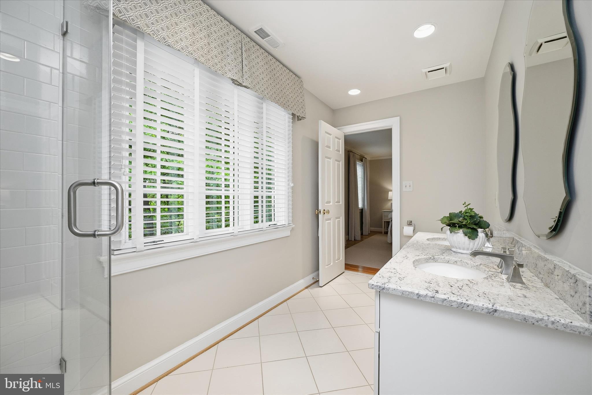 3824 Military Road Arlington, VA 22207 - Photo 33 of 54 a bathroom with a granite countertop sink and a mirror