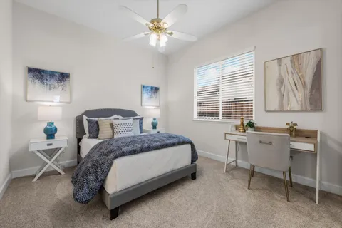 a spacious bedroom with a bed and a table