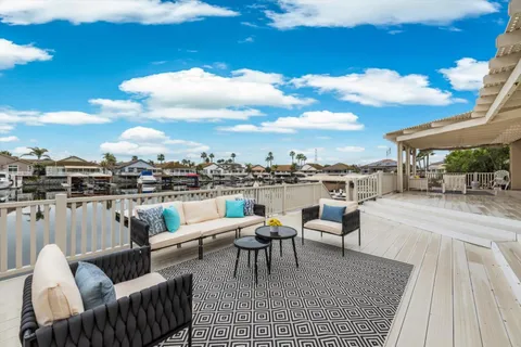 a view of a patio with couches table and chairs and potted plants