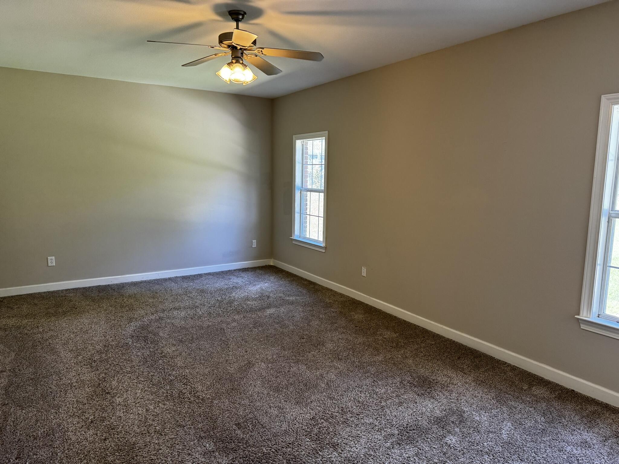 6102 Holloway Road Baker, FL 32531 - Photo 11 of 28 an empty room with a window and a ceiling fan