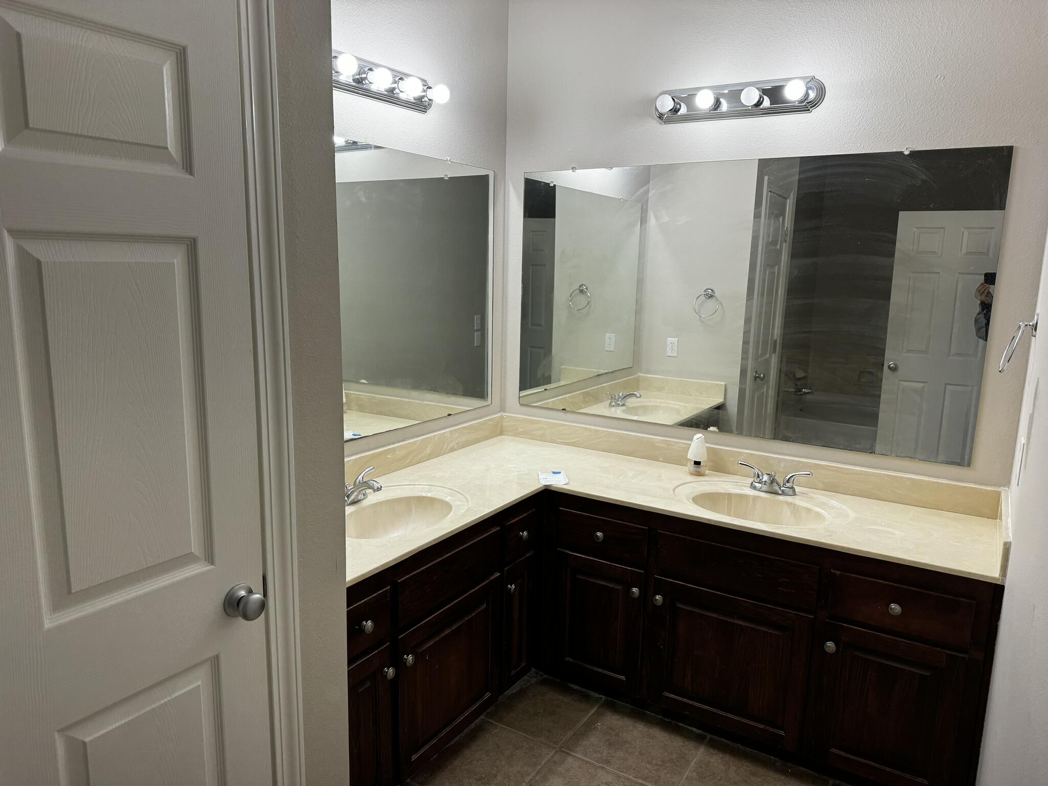 6102 Holloway Road Baker, FL 32531 - Photo 12 of 28 a bathroom with a sink double vanity and a mirror