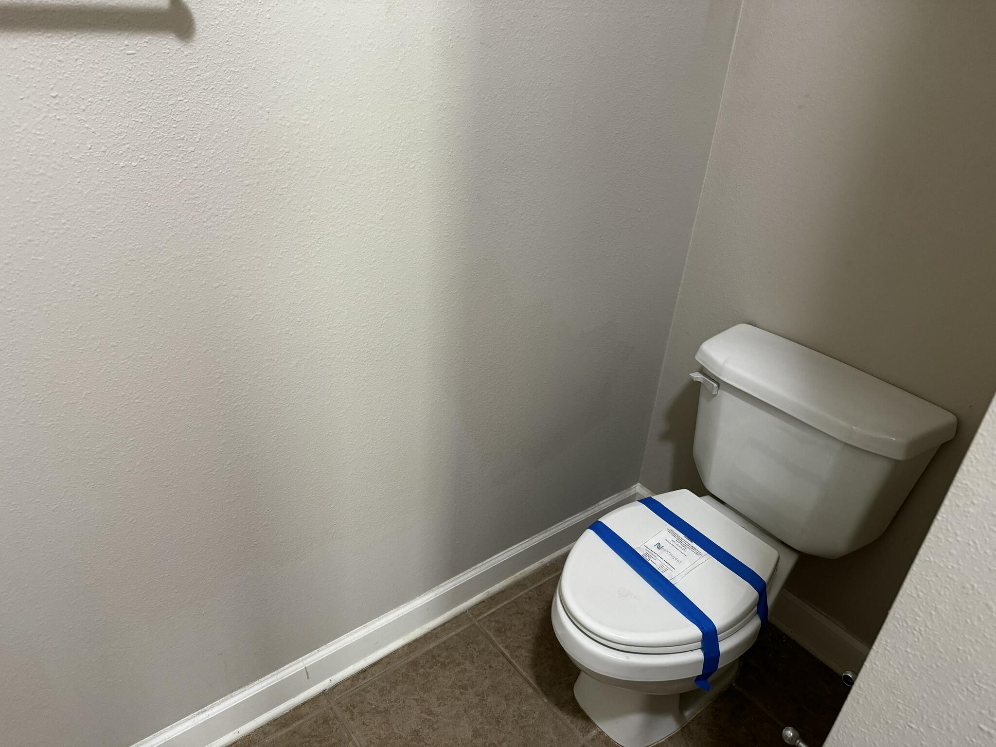 6102 Holloway Road Baker, FL 32531 - Photo 13 of 28 a white toilet sitting next to a wooden wall