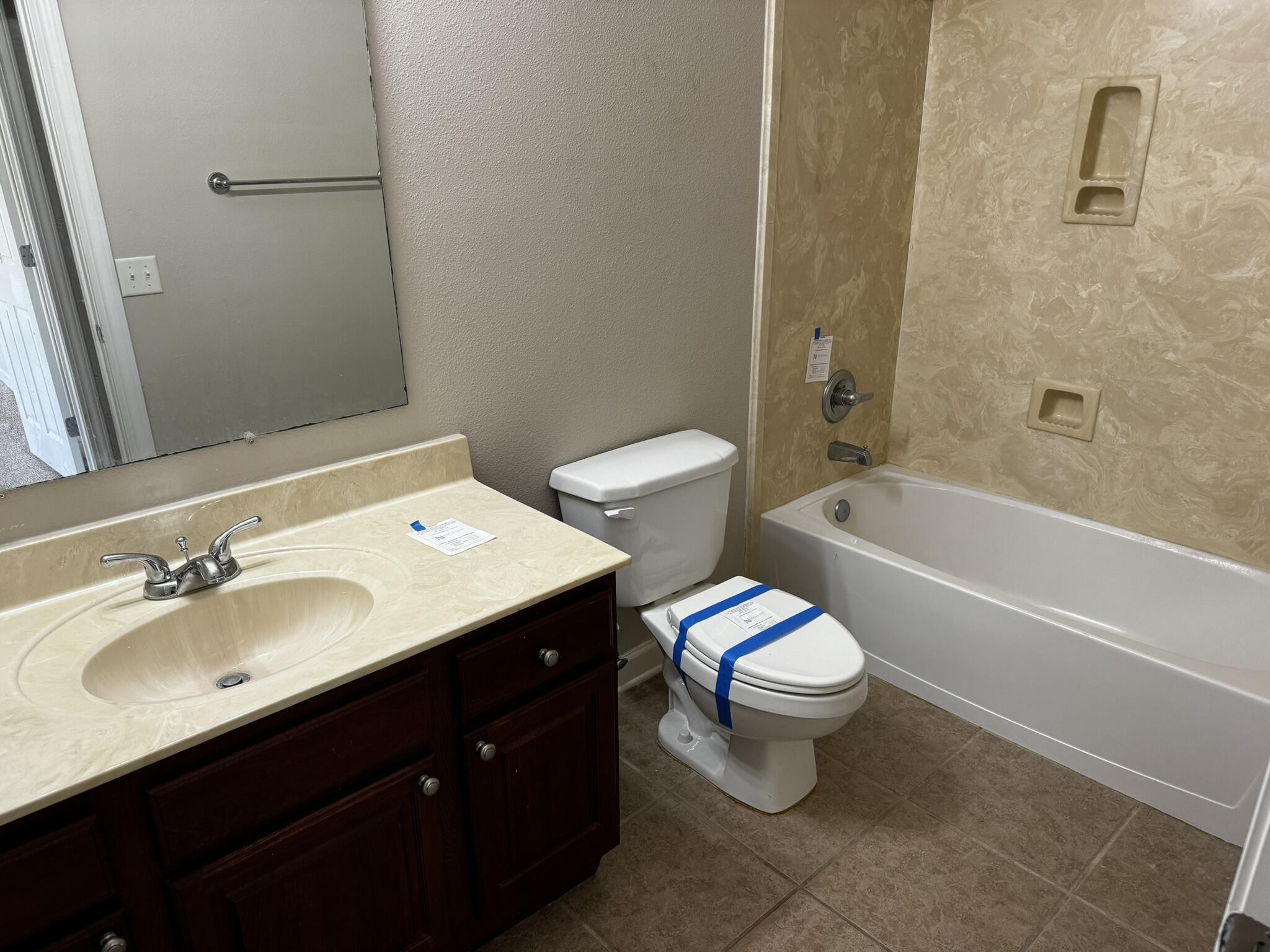 6102 Holloway Road Baker, FL 32531 - Photo 16 of 28 a bathroom with a sink toilet mirror vanity and bathtub