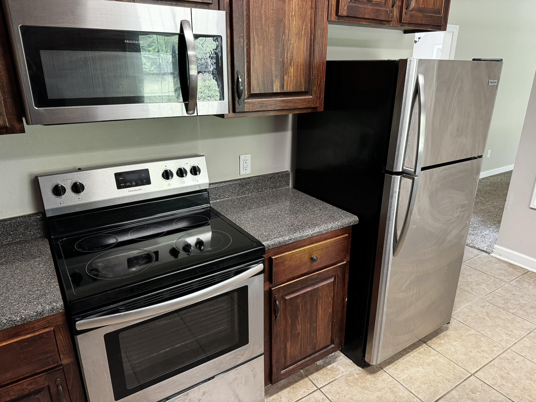 6102 Holloway Road Baker, FL 32531 - Photo 24 of 28 a kitchen with a stove microwave and refrigerator