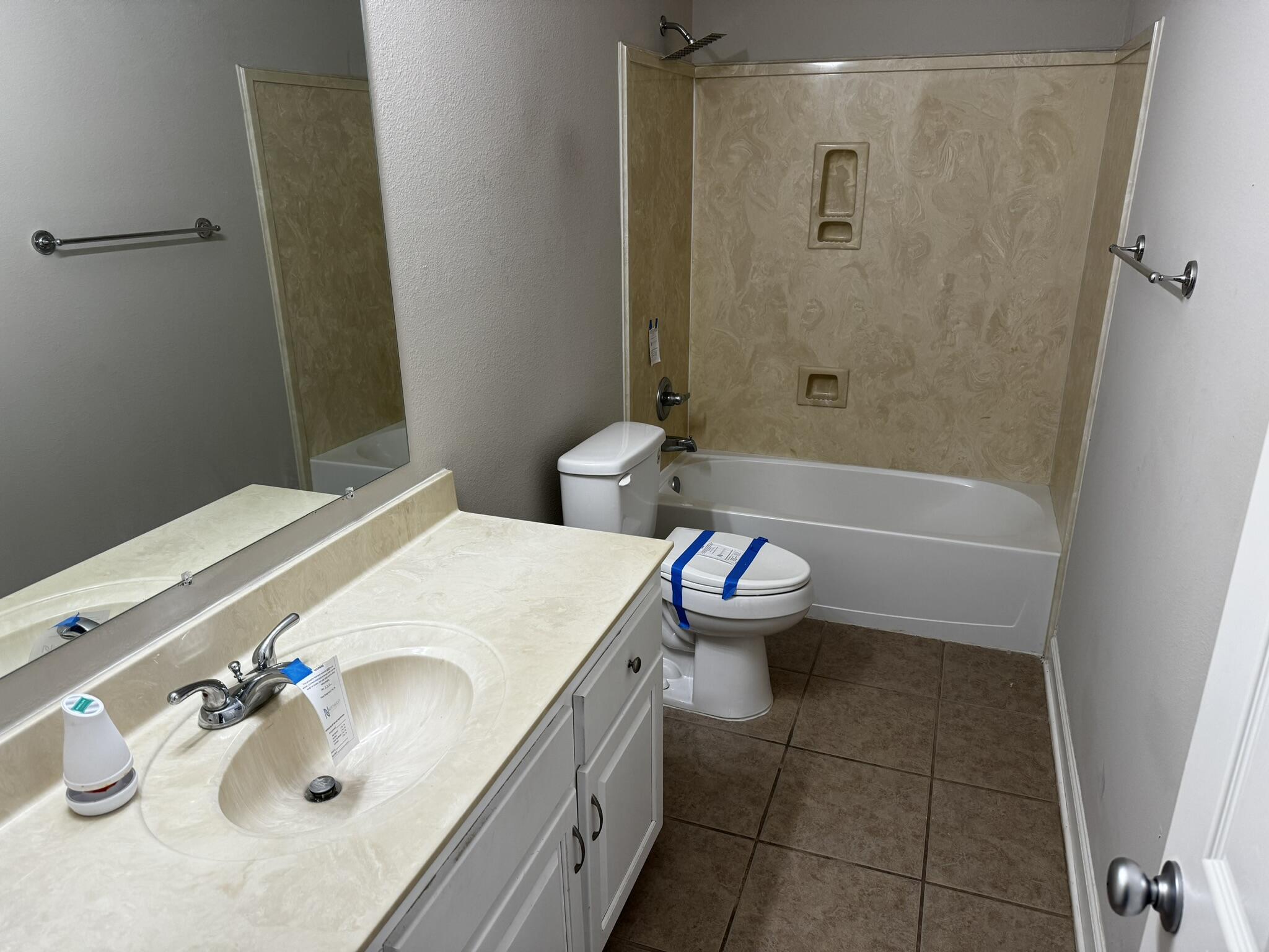 6102 Holloway Road Baker, FL 32531 - Photo 25 of 28 a bathroom with a sink a toilet and shower