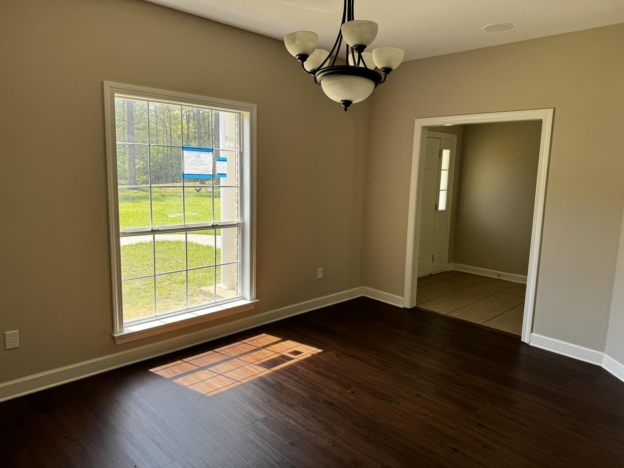 6102 Holloway Road Baker, FL 32531 - Photo 27 of 28 a view of an empty room with wooden floor and a window