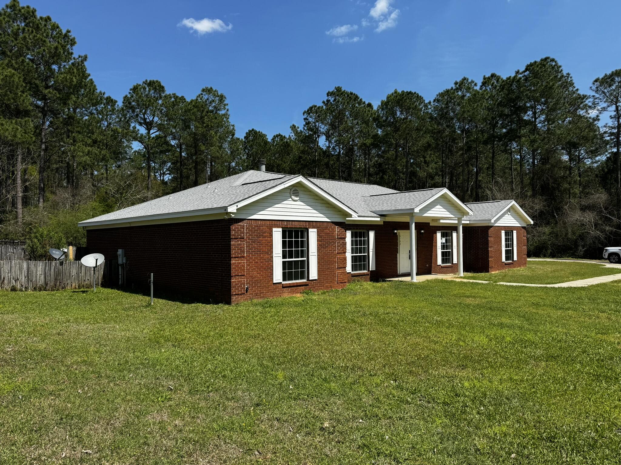 6102 Holloway Road Baker, FL 32531 - Photo 6 of 28 a front view of a house with yard and green space
