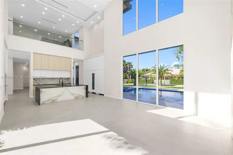 a spacious bedroom with a bed and a flat screen tv