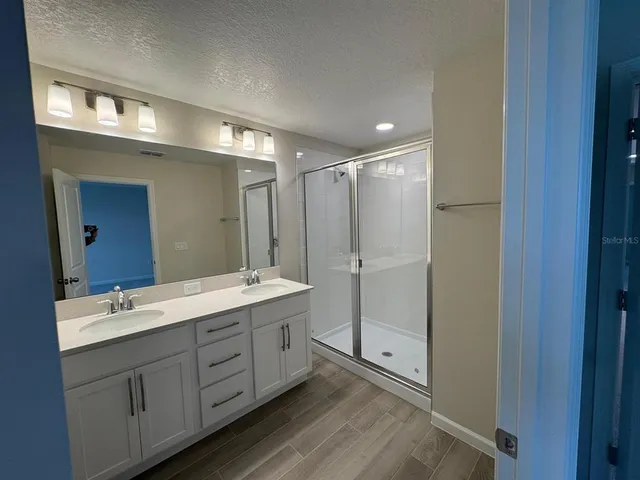 a bathroom with a double vanity sink mirror and double