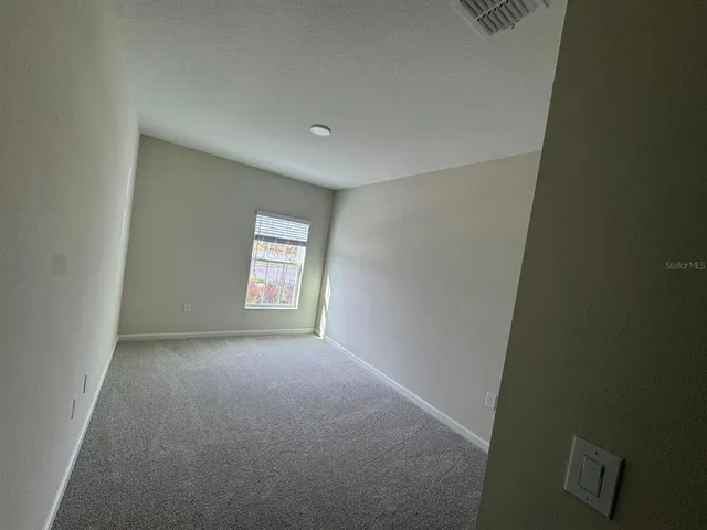 a view of an empty room and window