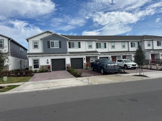 a front view of building with cars parked