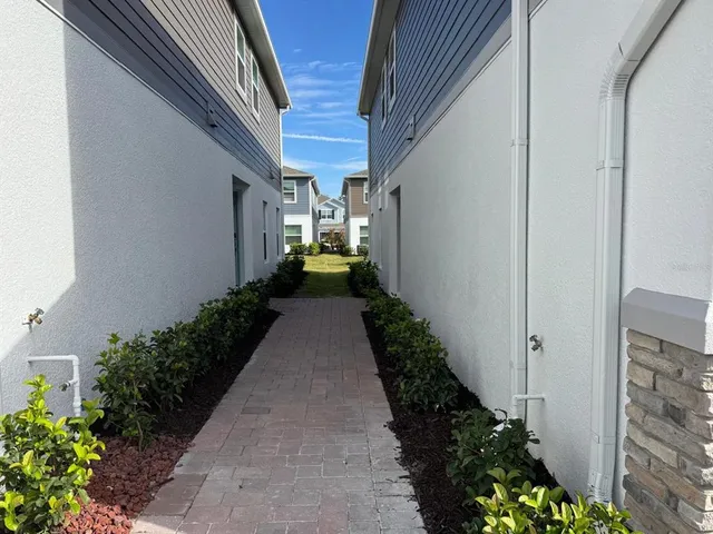 a view of a pathway with flower pots