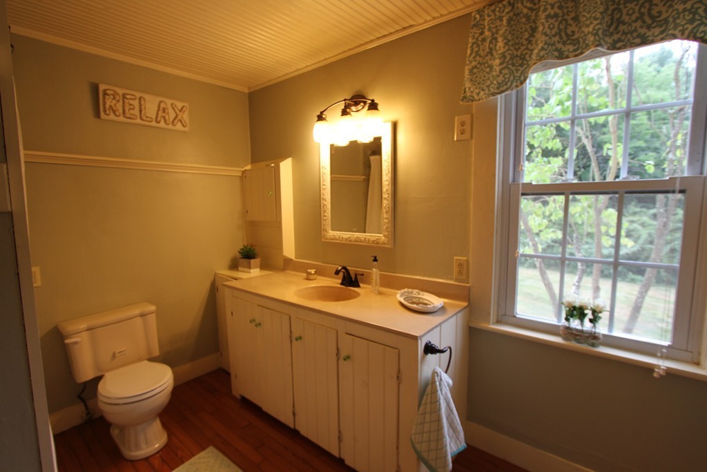 47 Locust Street Merrimac, MA 01860 - Photo 11 of 24 a bathroom with a toilet sink and mirror
