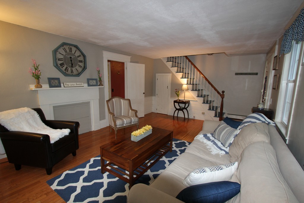 47 Locust Street Merrimac, MA 01860 - Photo 13 of 24 a living room with furniture a rug and a fireplace