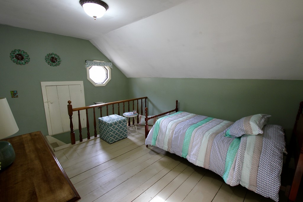 47 Locust Street Merrimac, MA 01860 - Photo 16 of 24 a bedroom with a bed and wooden floor