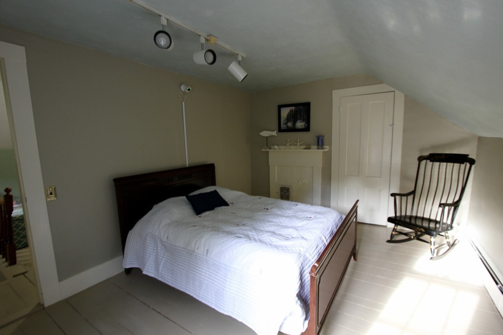 47 Locust Street Merrimac, MA 01860 - Photo 17 of 24 a bedroom with a bed and a chair