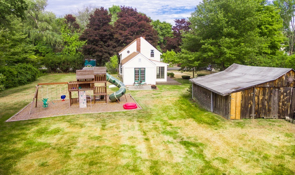 47 Locust Street Merrimac, MA 01860 - Photo 23 of 24 a aerial view of a house with table and chairs under an umbrella