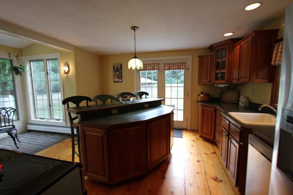 47 Locust Street Merrimac, MA 01860 - Photo 6 of 24 a kitchen with a sink stove and cabinets