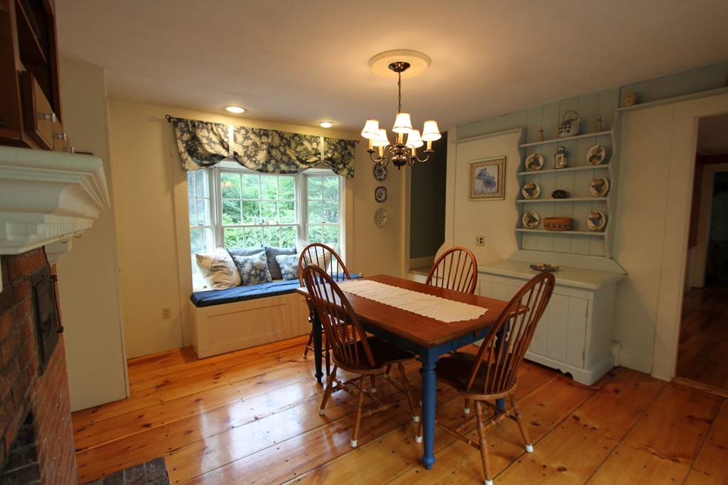 47 Locust Street Merrimac, MA 01860 - Photo 9 of 24 a view of a dining room with furniture a chandelier and wooden floor