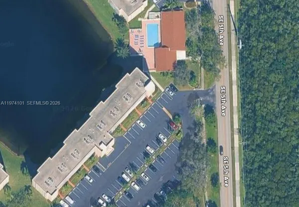 a view of a tall building next to a yard