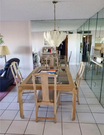 a dining room with furniture and chandelier kitchen view